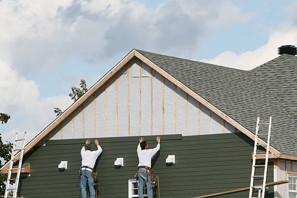 Professional Siding technician working in Brookville, NY